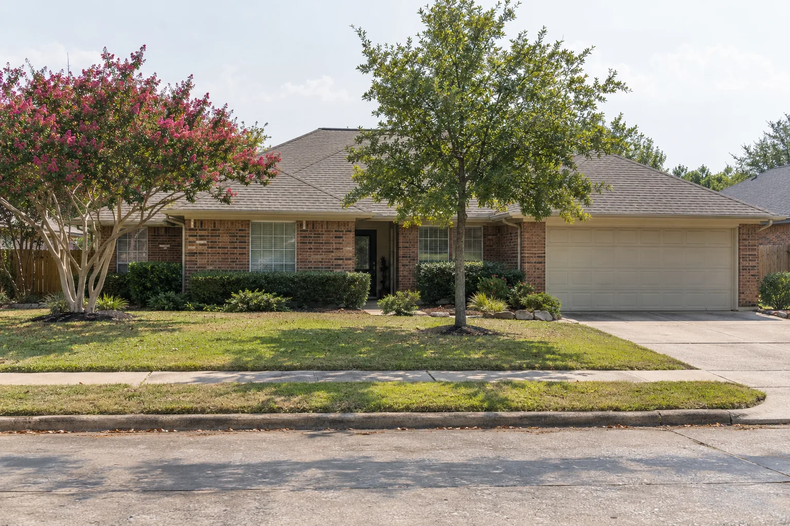 Single-storey brick ranch home on a flat lot in Houston, TX, a house type that often has an attic water heater
